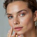 Close-up of radiant, healthy skin with natural elements like water droplets or flower petals.